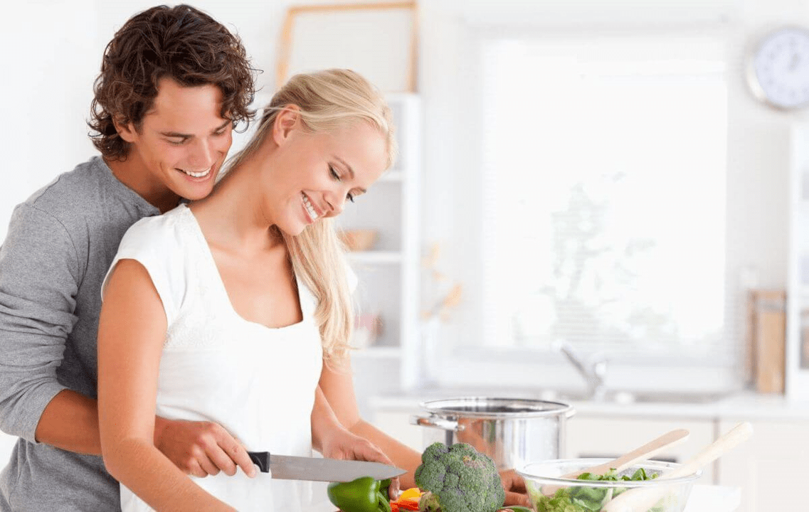 A young couple cooks